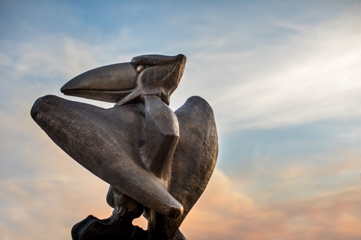Jayhawk statue and sunset sky